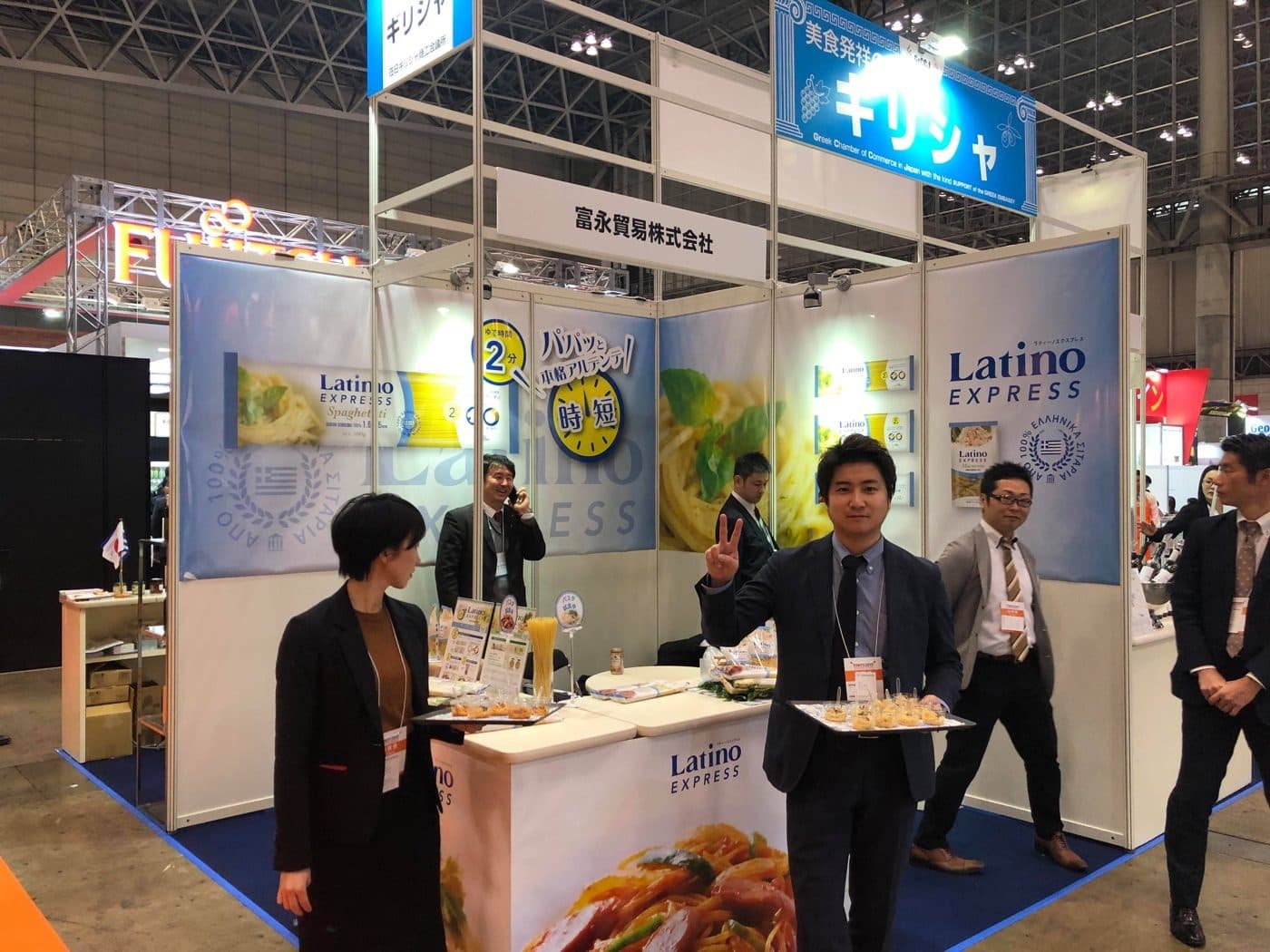 GrCCJ member companies exhibiting at a Tokyo trade fair, under a chamber banner noting the support of the Embassy of Greece